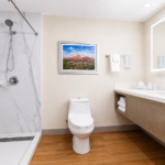 Bathroom in the Sedona View King Suite with walk-in shower, backlit vanity mirror and fresh towels