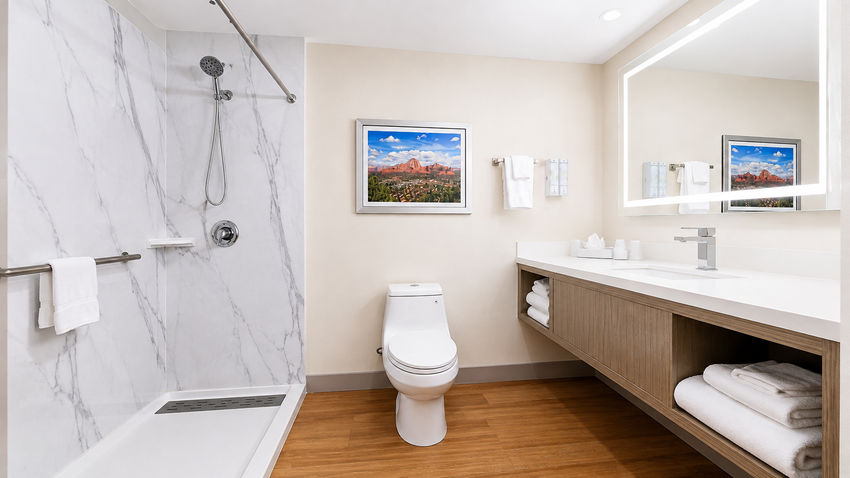 Bathroom in the Sedona View King Suite with walk-in shower, backlit vanity mirror and fresh towels