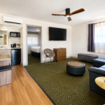 Living room of the Sedona View King Suite with sofa sleeper, ceiling fan and doorway through to the King bedroom