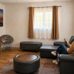 Guest relaxing on the sofa in the living room of the Sedona View King Suite