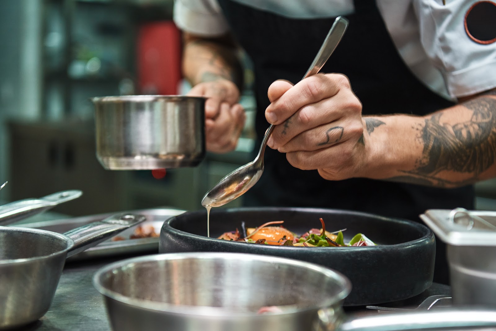 Chef plating a dish in a restaurant kitchen