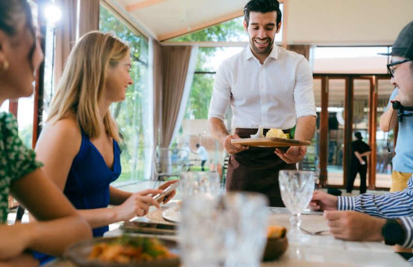 Server bringing dishes to a large group table at a Sedona restaurant