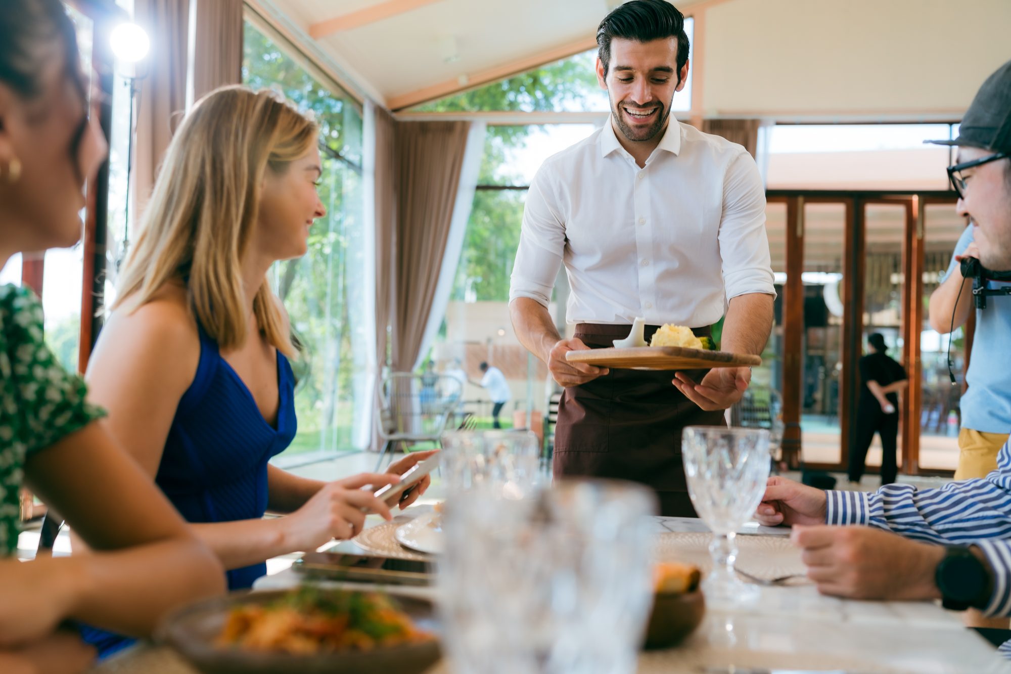Server bringing dishes to a large group table at a Sedona restaurant