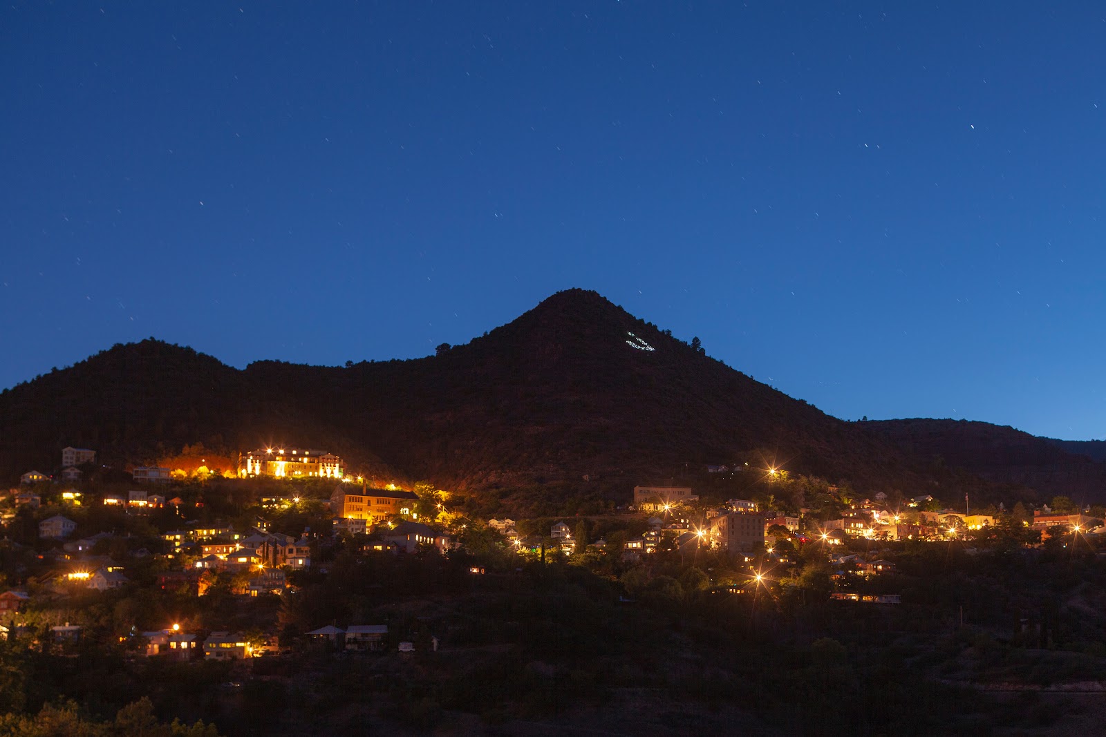 The historic hillside town of Jerome, Arizona, glowing at dusk above the Verde Valley