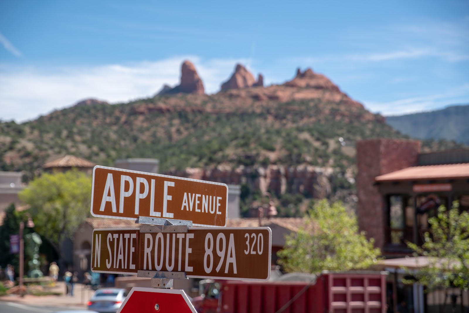 Route 89A sign with Sedona's red rocks behind, the start of the scenic drive through Oak Creek Canyon to Flagstaff
