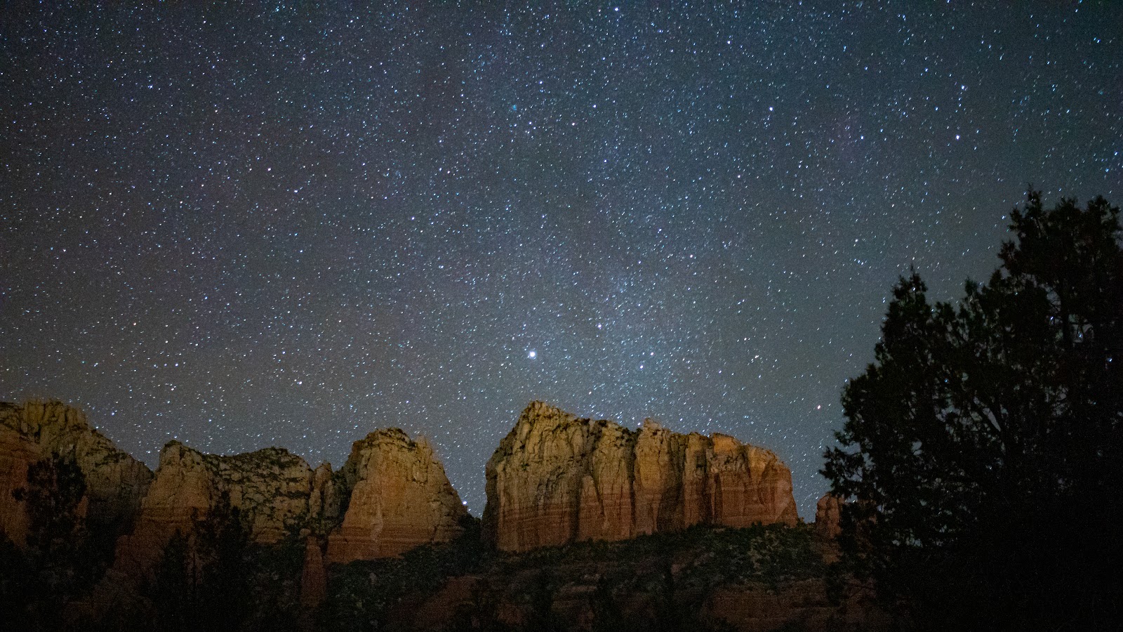 A sky full of stars over Sedona's red rock cliffs, an International Dark Sky Community